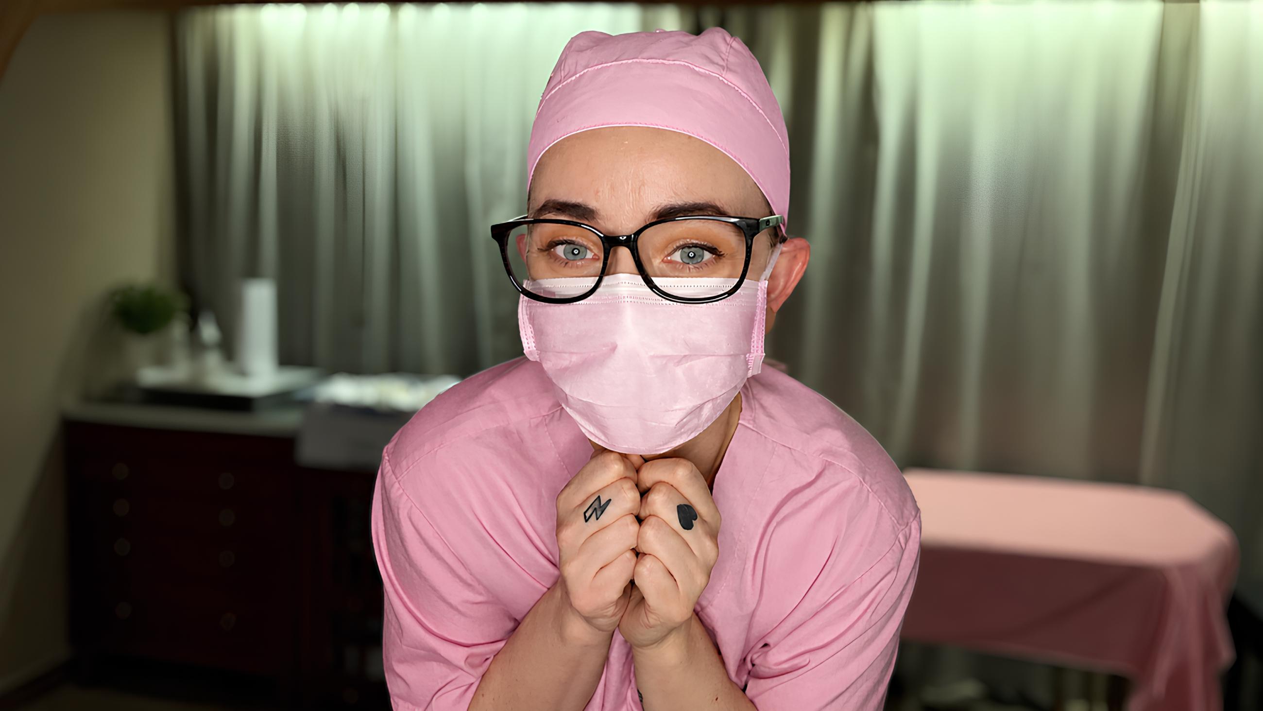 Miss Nena bdsm medical assistant wearing pink scrubs while organizing tools in the clinic