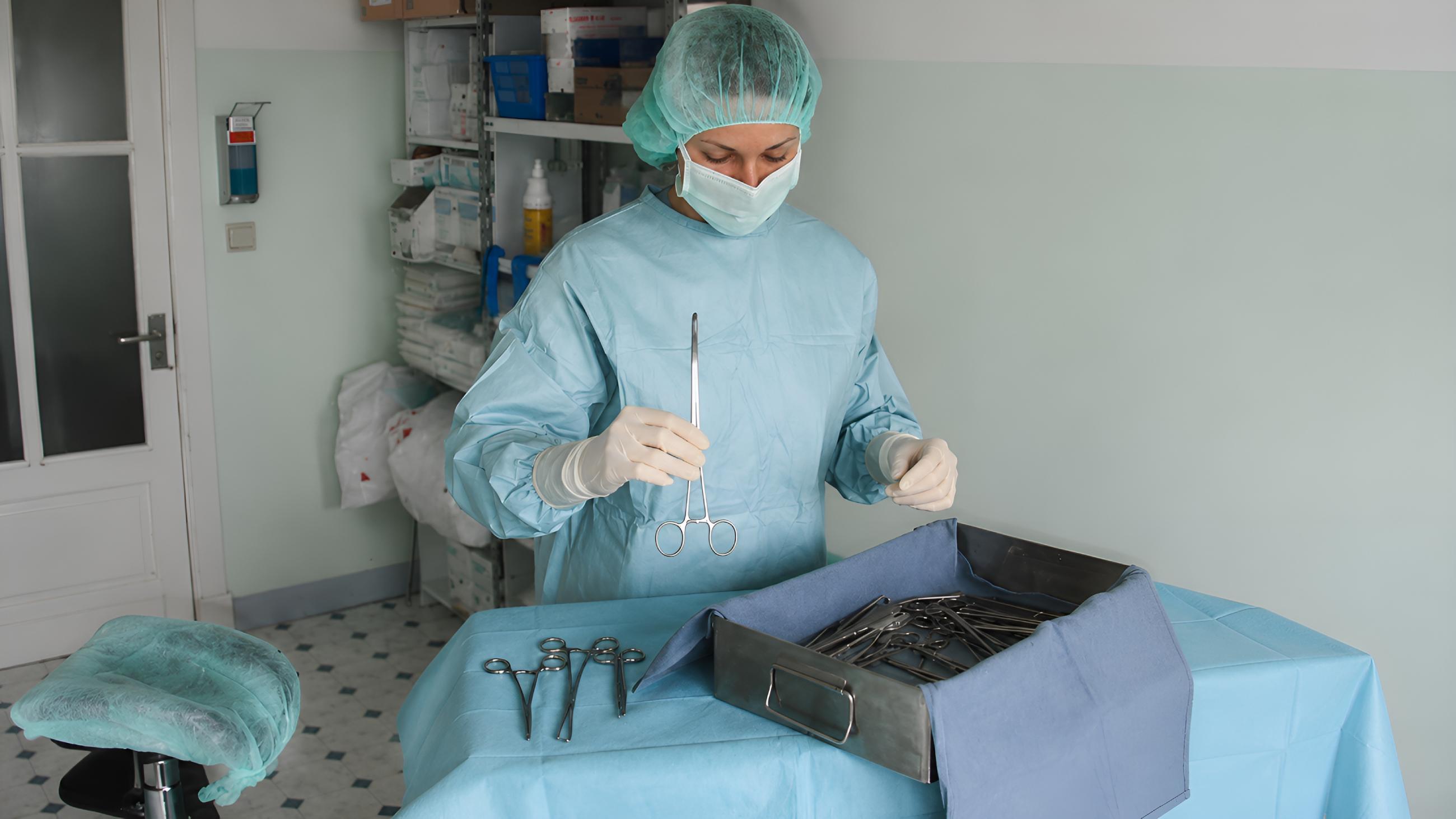 Mistress surgeon preparing instruments in O.R.R. Belgium setup